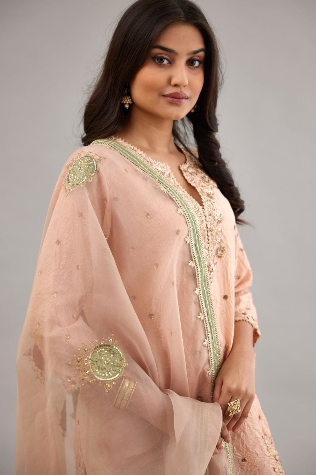 Pink hand crushed silk short kurta set with all-over gold sequins and zari handwork, highlighted with gota lace at edges.