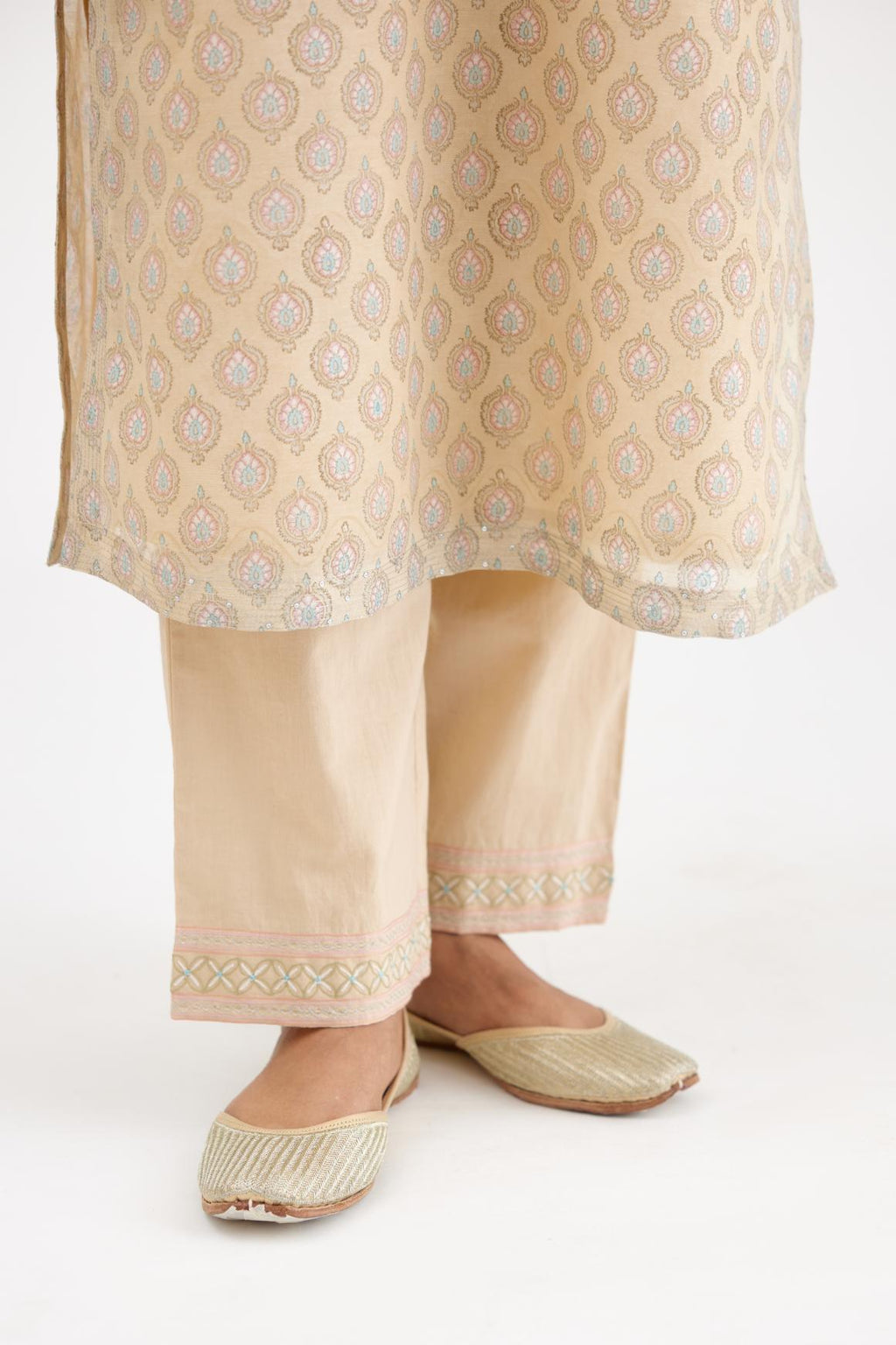 Beige silk Chanderi straight kurta set with all-over hand block print and detailed with silver zari quilting and sequin hand work.