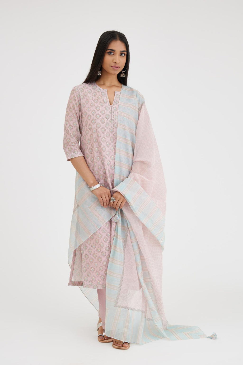 Pink silk Chanderi straight kurta set with all-over hand block print and detailed with silver zari quilting and sequins hand work.