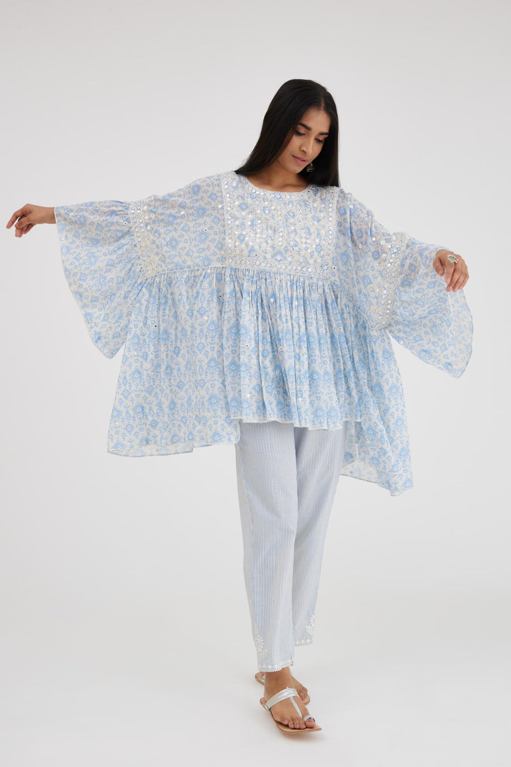 Ikat design blue and off white hand block printed cotton easy fit top with flared sleeves and hem, paired with hand-block printed striped Cotton comfortable fit pant with all-over elasticated waisband.