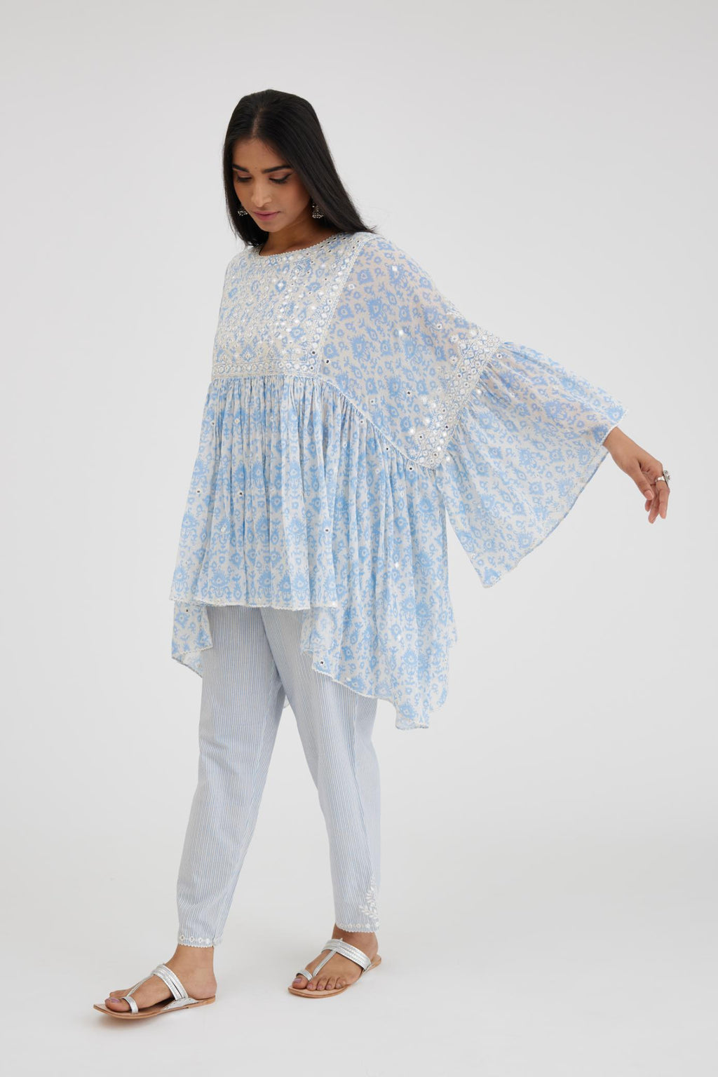 Ikat design blue and off white hand block printed cotton easy fit top with flared sleeves and hem, paired with hand-block printed striped Cotton comfortable fit pant with all-over elasticated waisband.