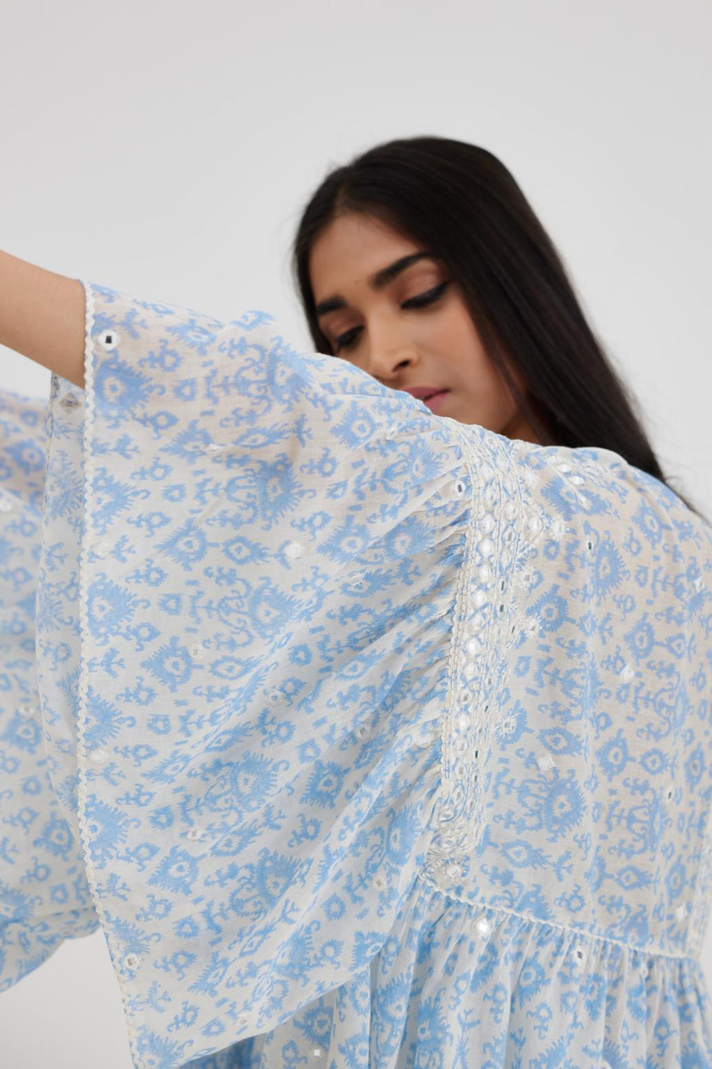 Ikat design blue and off white hand block printed cotton easy fit top with flared sleeves and hem, paired with hand-block printed striped Cotton comfortable fit pant with all-over elasticated waisband.