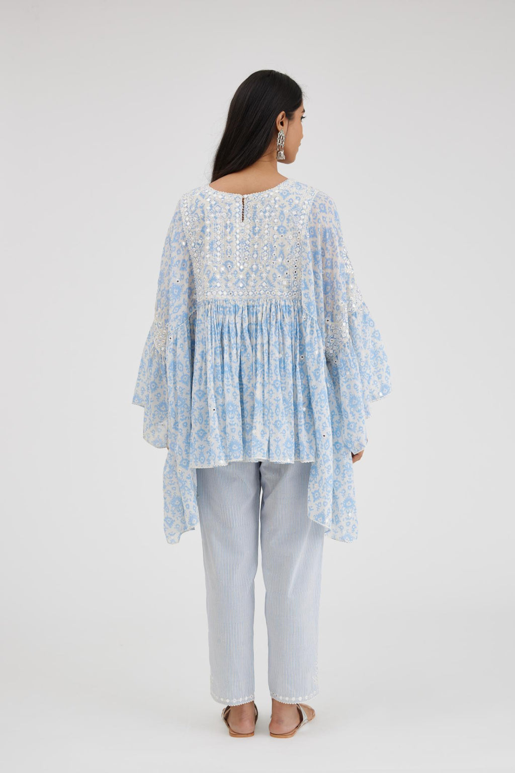 Ikat design blue and off white hand block printed cotton easy fit top with flared sleeves and hem, paired with hand-block printed striped Cotton comfortable fit pant with all-over elasticated waisband.