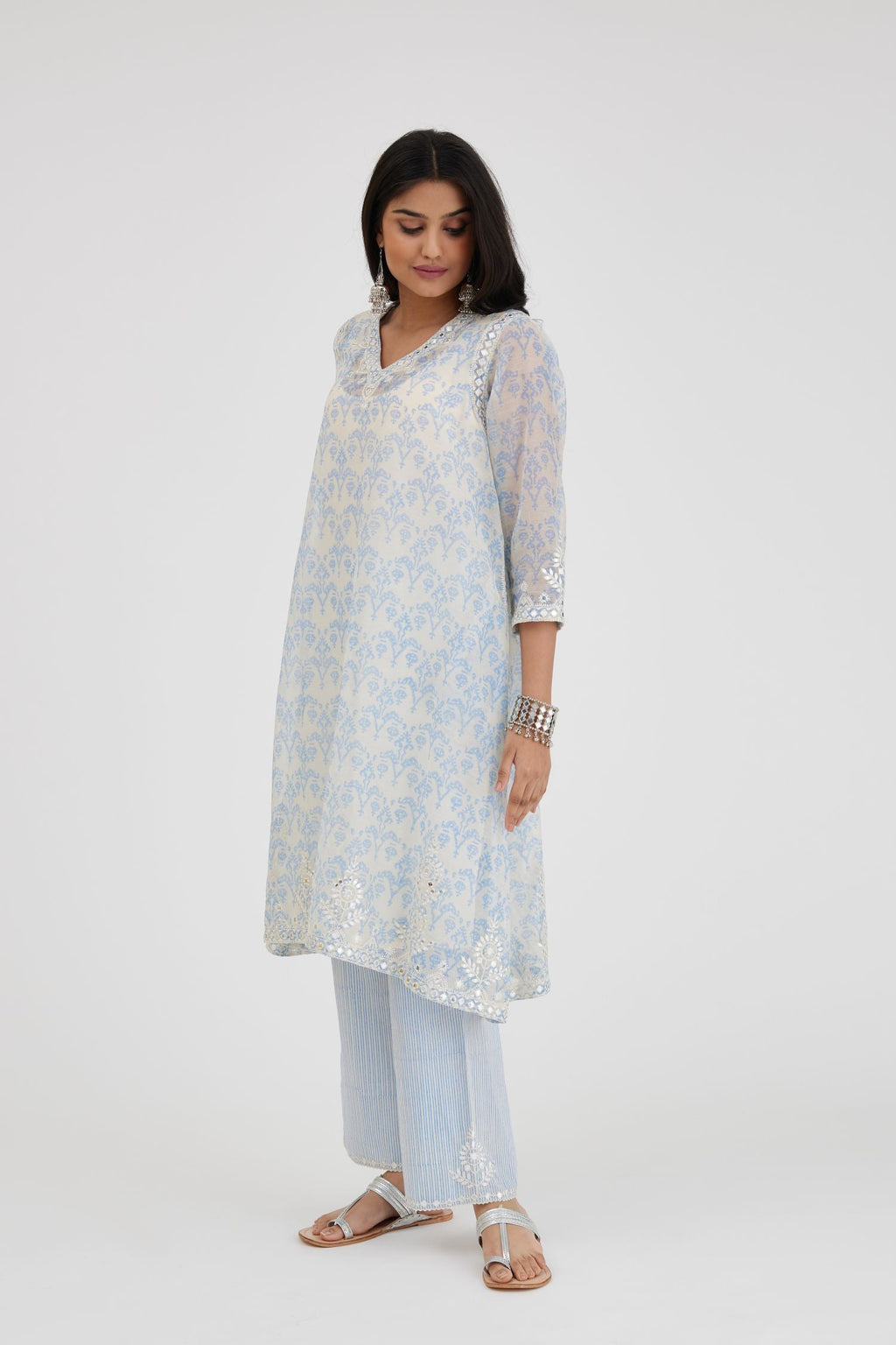 Blue and off white cotton chanderi Ikat design hand-block printed A-line short kurta set with V-neck and asymmetric hem.