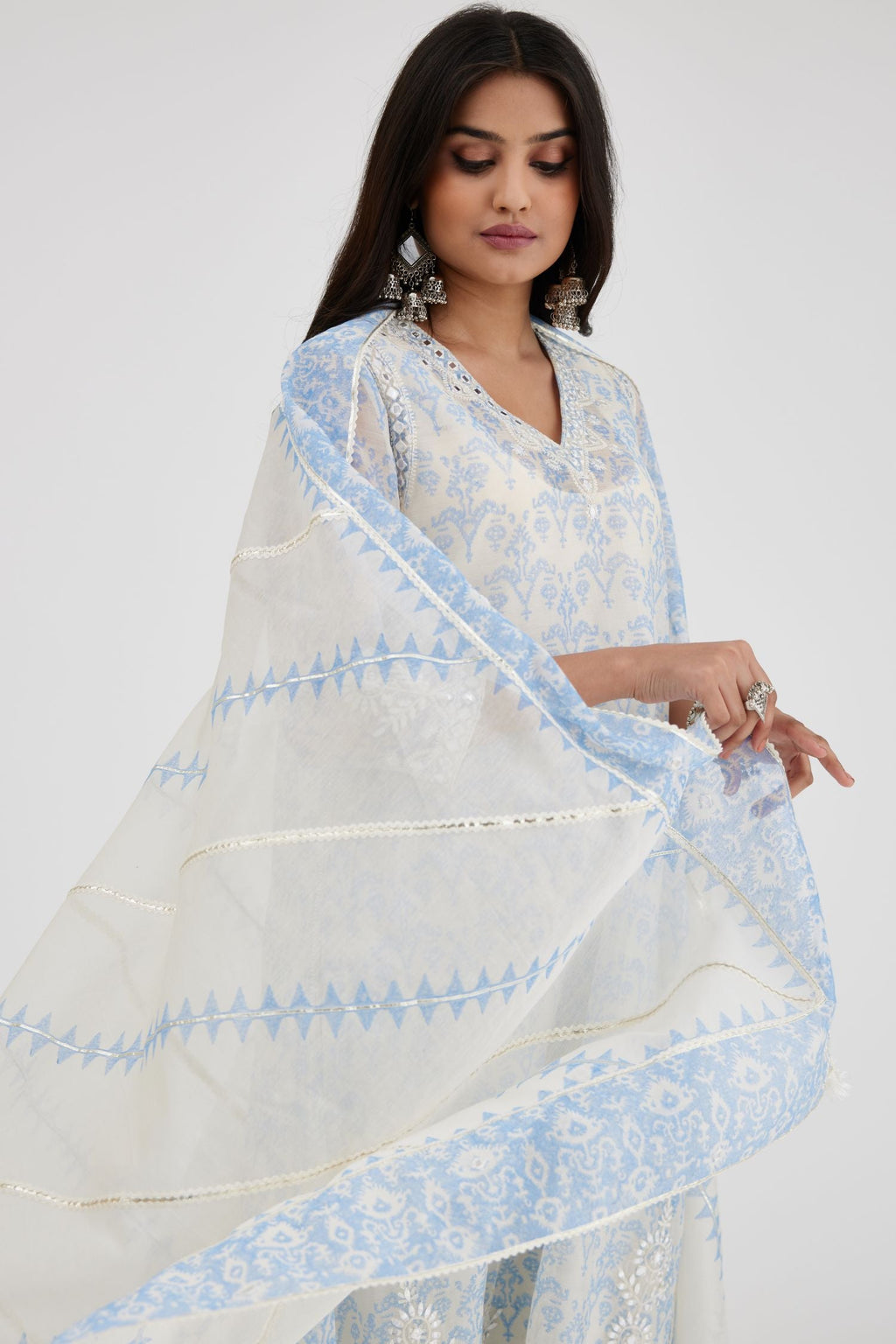 Blue and off white cotton chanderi Ikat design hand-block printed A-line short kurta set with V-neck and asymmetric hem.