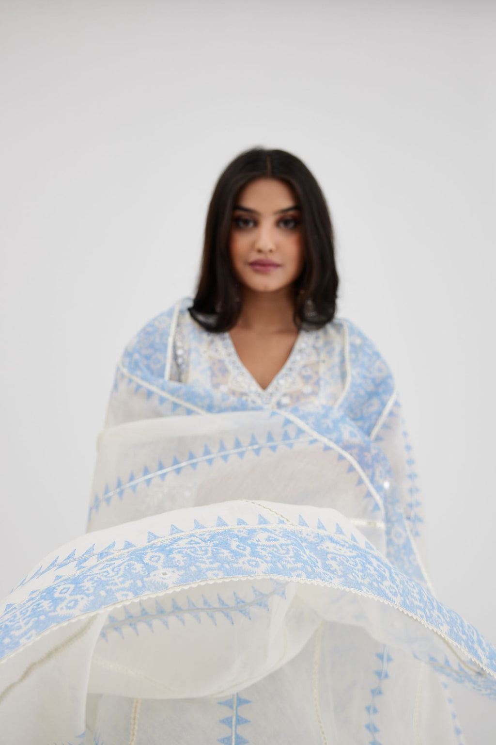 Blue and off white cotton chanderi Ikat design hand-block printed A-line short kurta set with V-neck and asymmetric hem.