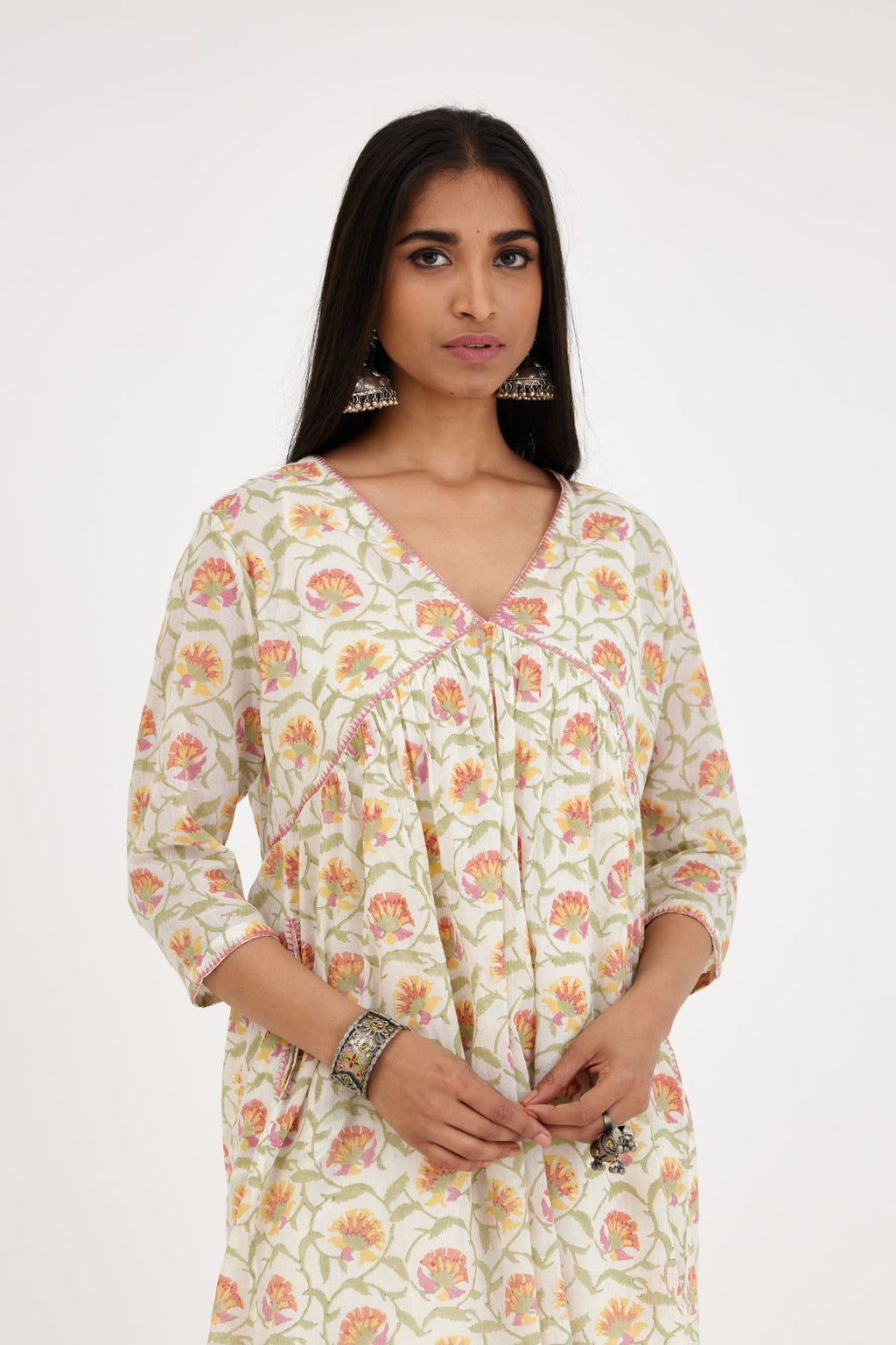 Pink and green hand blcok printed cotton short kurta, highlighted with zig-zag silk thread embroidery at edges, paired with pink and green hand-block printed striped cotton comfortable fit pants.