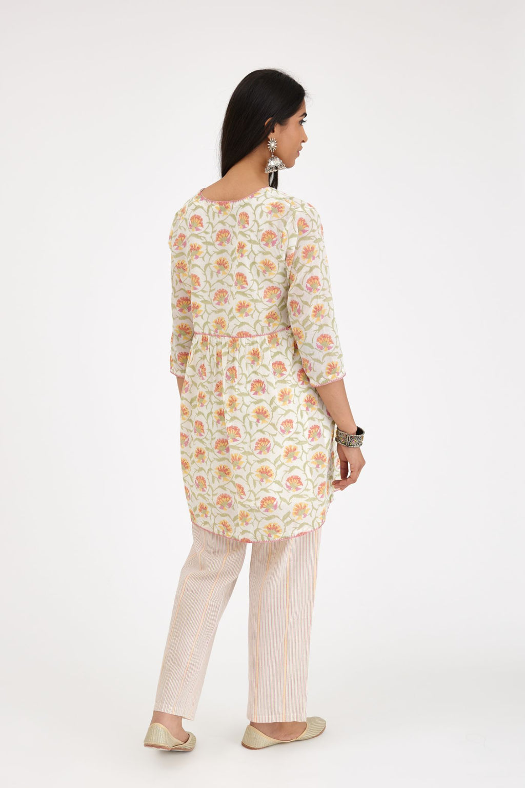 Pink and green hand blcok printed cotton short kurta, highlighted with zig-zag silk thread embroidery at edges, paired with pink and green hand-block printed striped cotton comfortable fit pants.