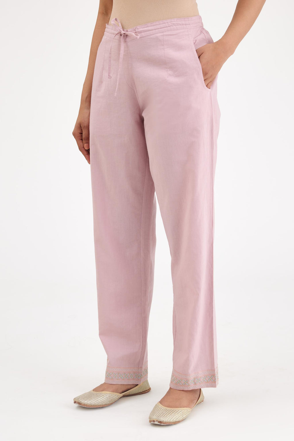 Pink cotton straight pants with multi colored thread embroidery, highlighted with silver zari embroidery at bottom hem