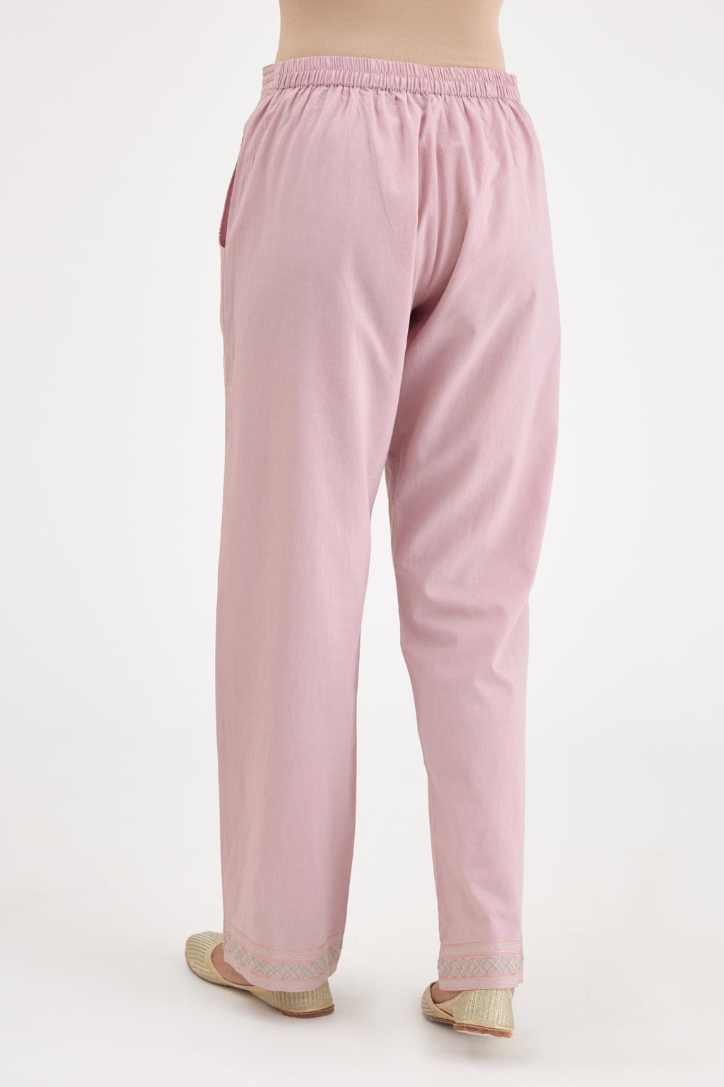 Pink cotton straight pants with multi colored thread embroidery, highlighted with silver zari embroidery at bottom hem