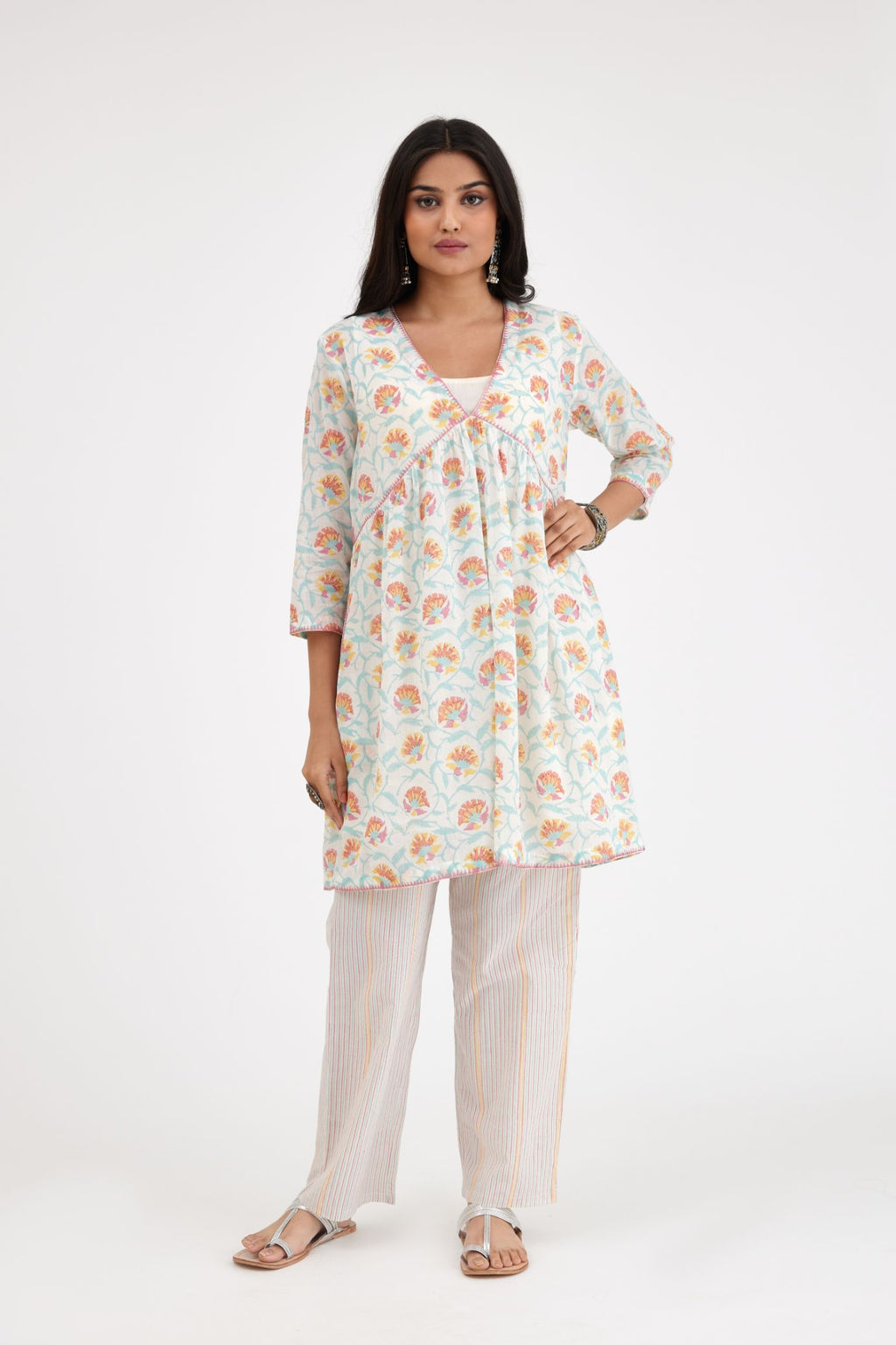 Pink and blue hand blcok printed cotton short kurta, highlighted with zig-zag silk thread embroidery at edges, paired with pink and blue hand-block printed striped cotton comfortable fit pants.