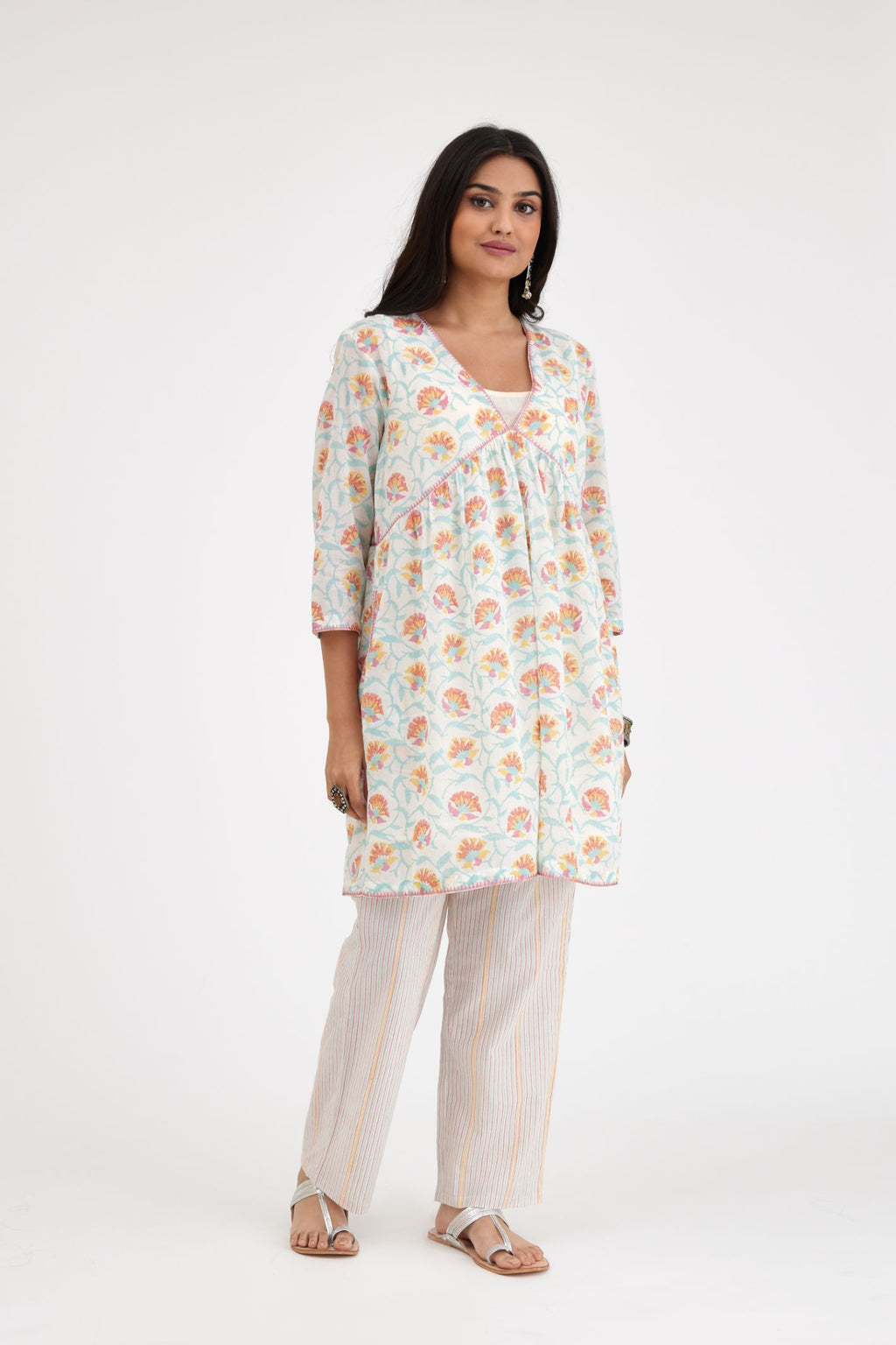 Pink and blue hand blcok printed cotton short kurta, highlighted with zig-zag silk thread embroidery at edges, paired with pink and blue hand-block printed striped cotton comfortable fit pants.