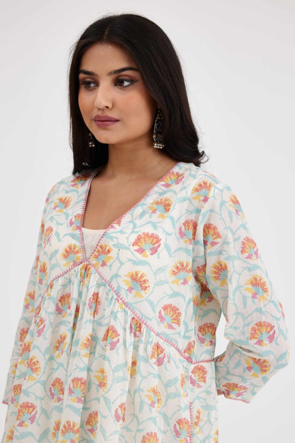 Pink and blue hand blcok printed cotton short kurta, highlighted with zig-zag silk thread embroidery at edges, paired with pink and blue hand-block printed striped cotton comfortable fit pants.