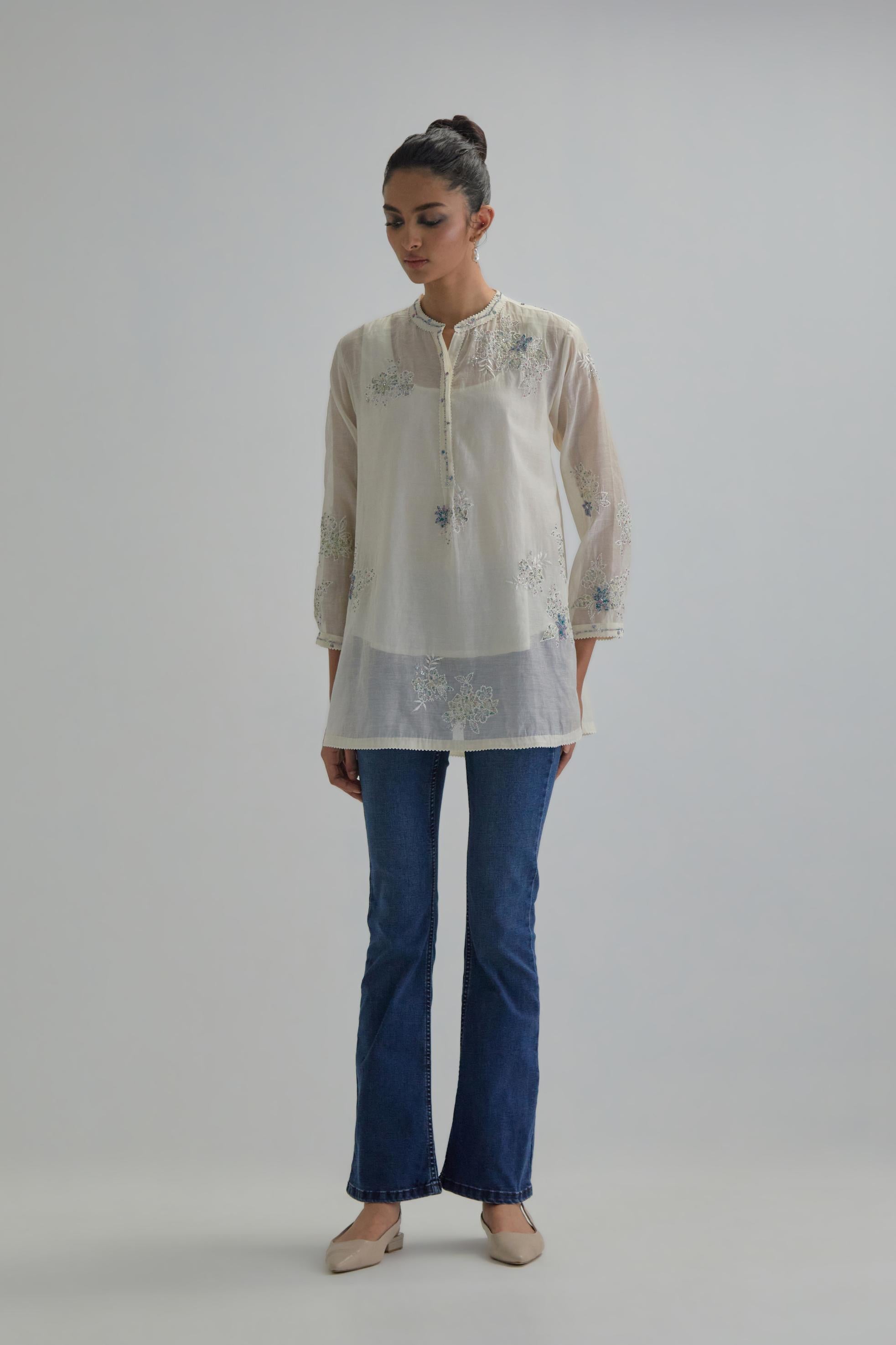 Off white cotton Chanderi top with all-over delicate embroidered blue & beige hand block printed applique flowers, highlighted with sequins and multi coloured beads.