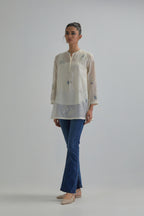 Off white cotton Chanderi top with all-over delicate embroidered blue & beige hand block printed applique flowers, highlighted with sequins and multi coloured beads.