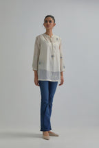 Off white cotton Chanderi top with all-over delicate embroidered blue & beige hand block printed applique flowers, highlighted with sequins and multi coloured beads.