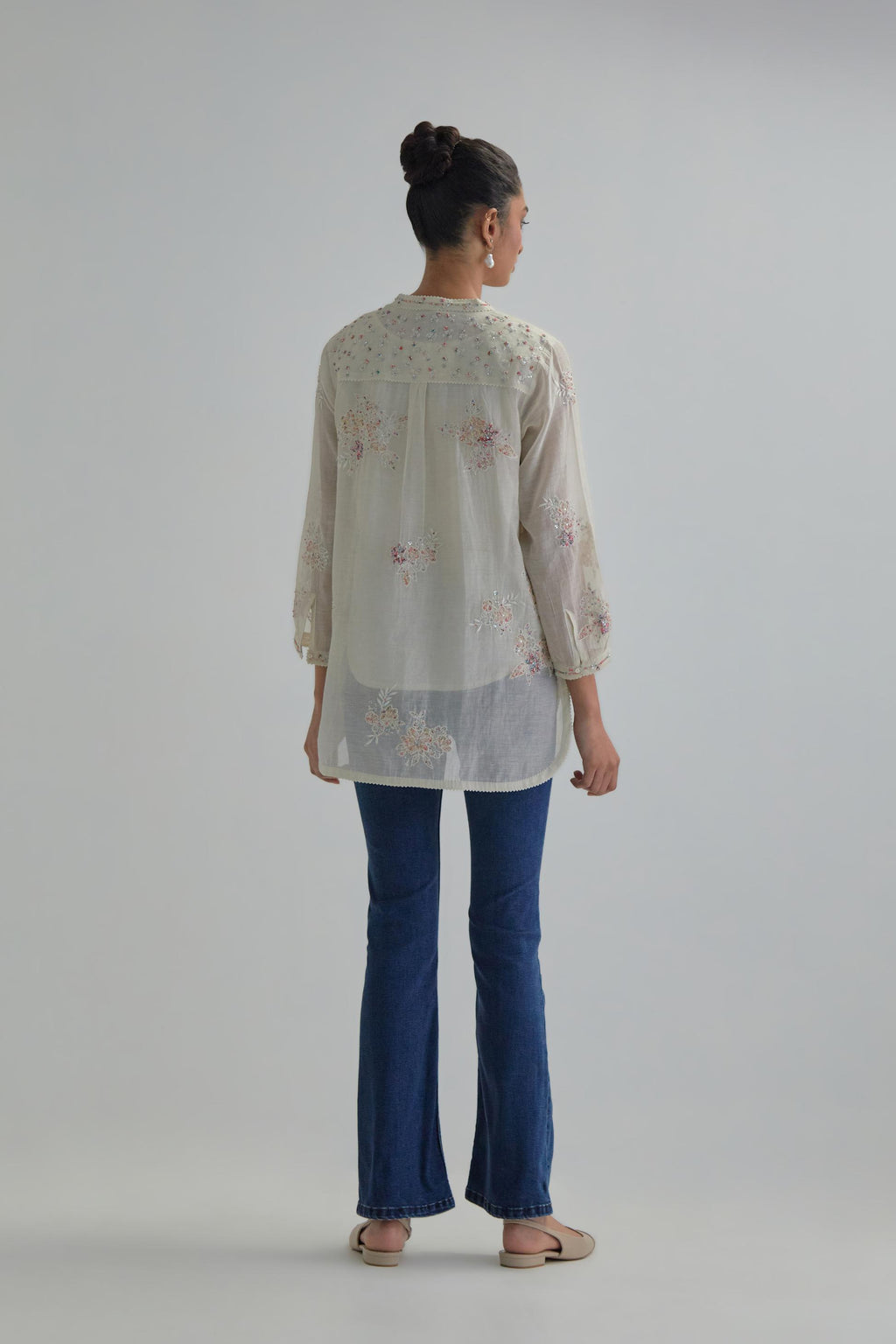 Off white cotton Chanderi top with all-over delicate embroidered pink & beige hand block printed applique flowers, highlighted with sequins and multi coloured beads.