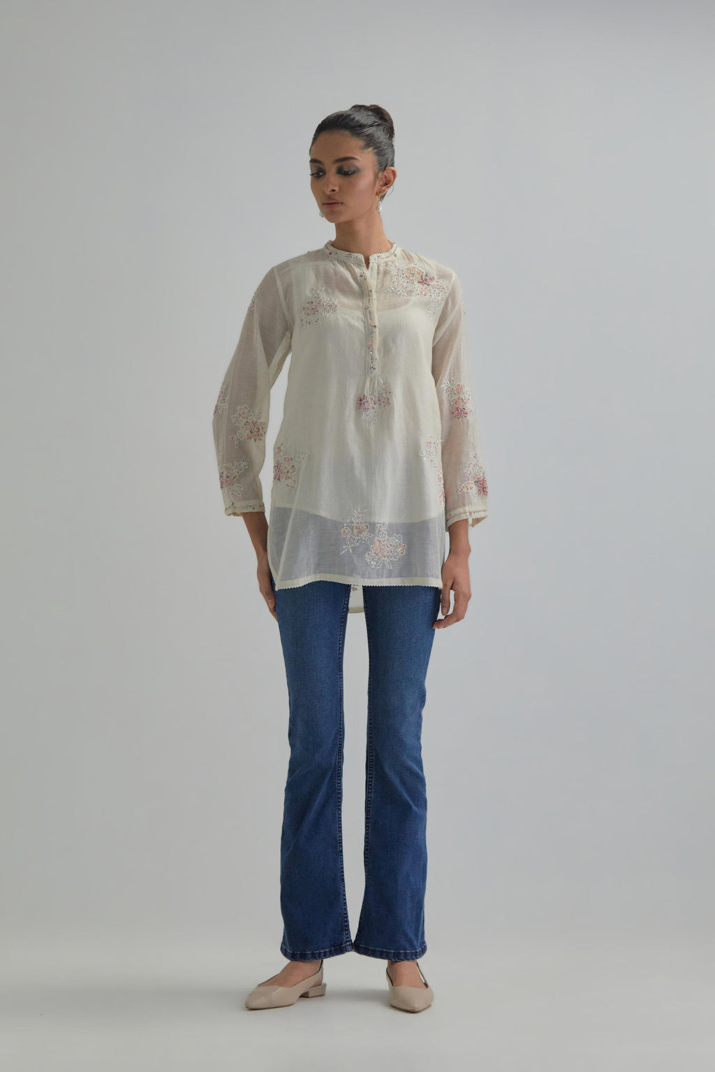 Off white cotton Chanderi top with all-over delicate embroidered pink & beige hand block printed applique flowers, highlighted with sequins and multi coloured beads.