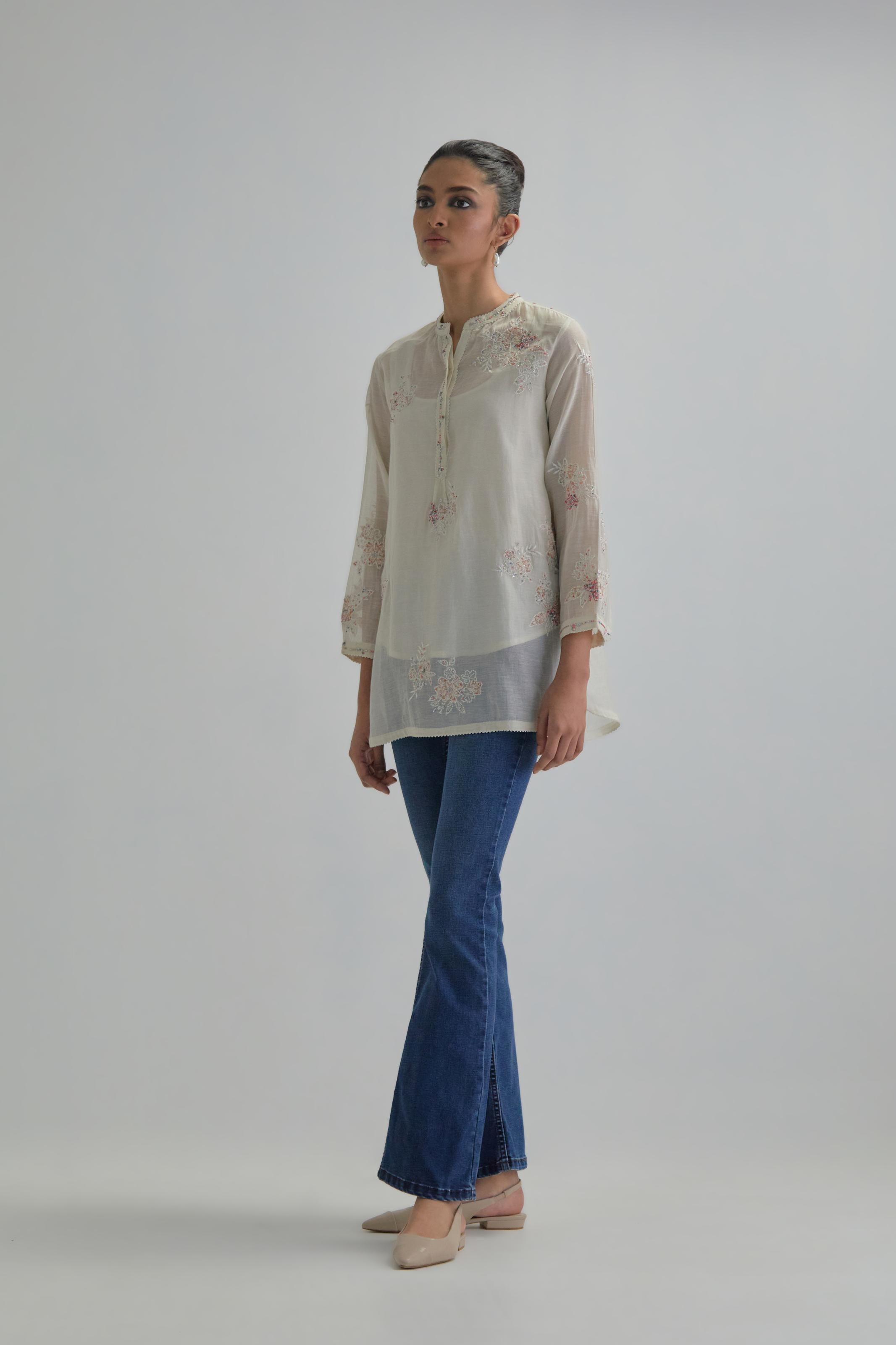 Off white cotton Chanderi top with all-over delicate embroidered pink & beige hand block printed applique flowers, highlighted with sequins and multi coloured beads.