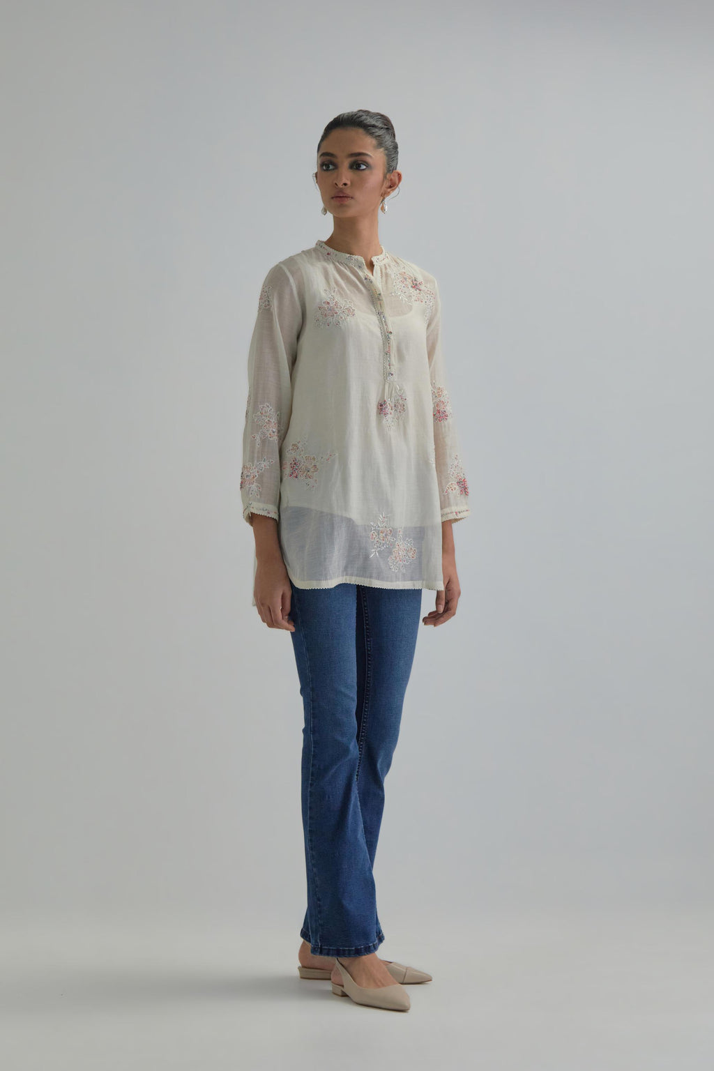 Off white cotton Chanderi top with all-over delicate embroidered pink & beige hand block printed applique flowers, highlighted with sequins and multi coloured beads.