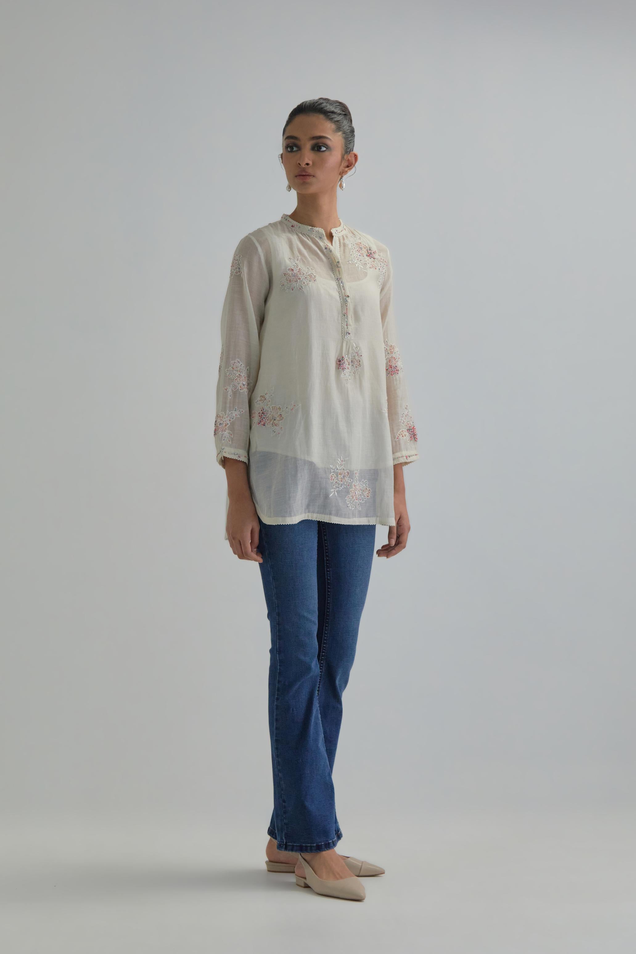 Off white cotton Chanderi top with all-over delicate embroidered pink & beige hand block printed applique flowers, highlighted with sequins and multi coloured beads.