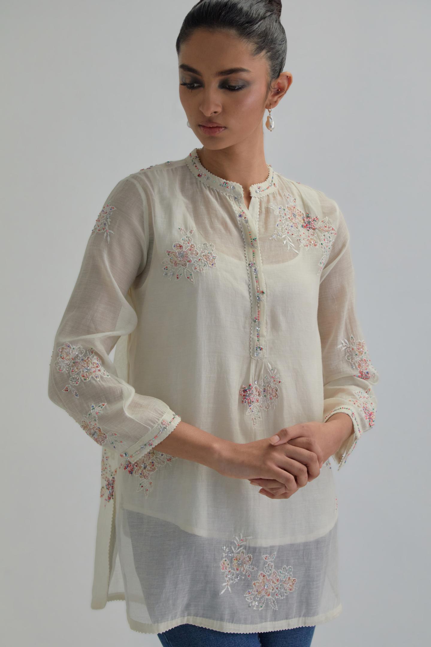 Off white cotton Chanderi top with all-over delicate embroidered pink & beige hand block printed applique flowers, highlighted with sequins and multi coloured beads.