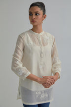 Off white cotton Chanderi top with all-over delicate embroidered applique flowers, highlighted with sequins and beads.