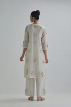 Off white straight short kurta set with all-over pink & beige hand block printed appliqué motifs, highlighted with sequins and multi coloured beads.