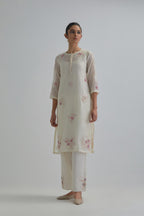 Off white straight short kurta set with all-over pink & beige hand block printed appliqué motifs, highlighted with sequins and multi coloured beads.