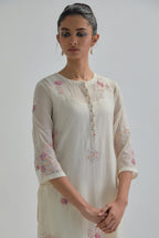 Off white straight short kurta set with all-over pink & beige hand block printed appliqué motifs, highlighted with sequins and multi coloured beads.