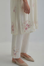 Off white straight short kurta set with all-over pink & beige hand block printed appliqué motifs, highlighted with sequins and multi coloured beads.