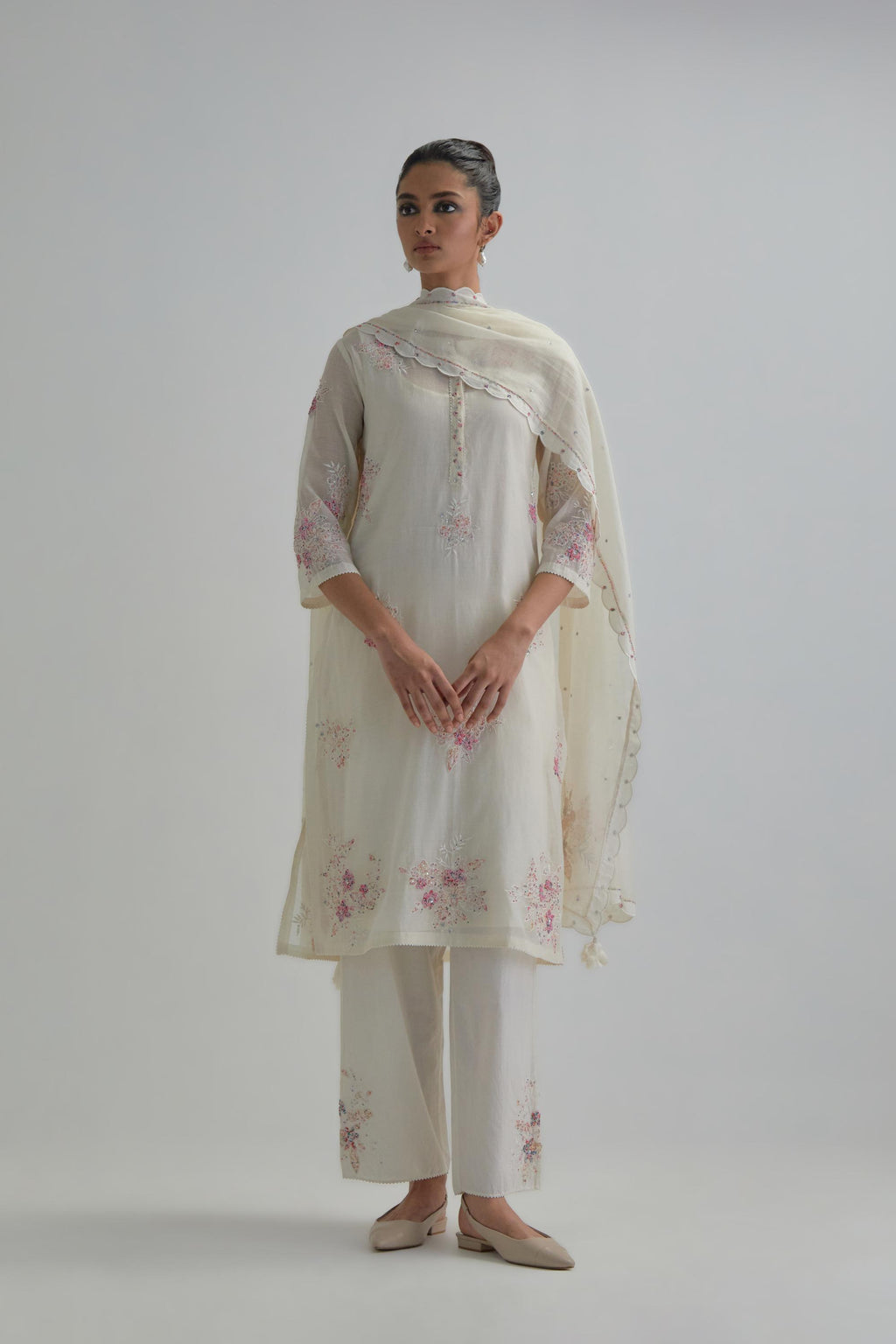 Off white straight short kurta set with all-over pink & beige hand block printed appliqué motifs, highlighted with sequins and multi coloured beads.