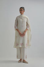 Off white straight short kurta set with all-over pink & beige hand block printed appliqué motifs, highlighted with sequins and multi coloured beads.