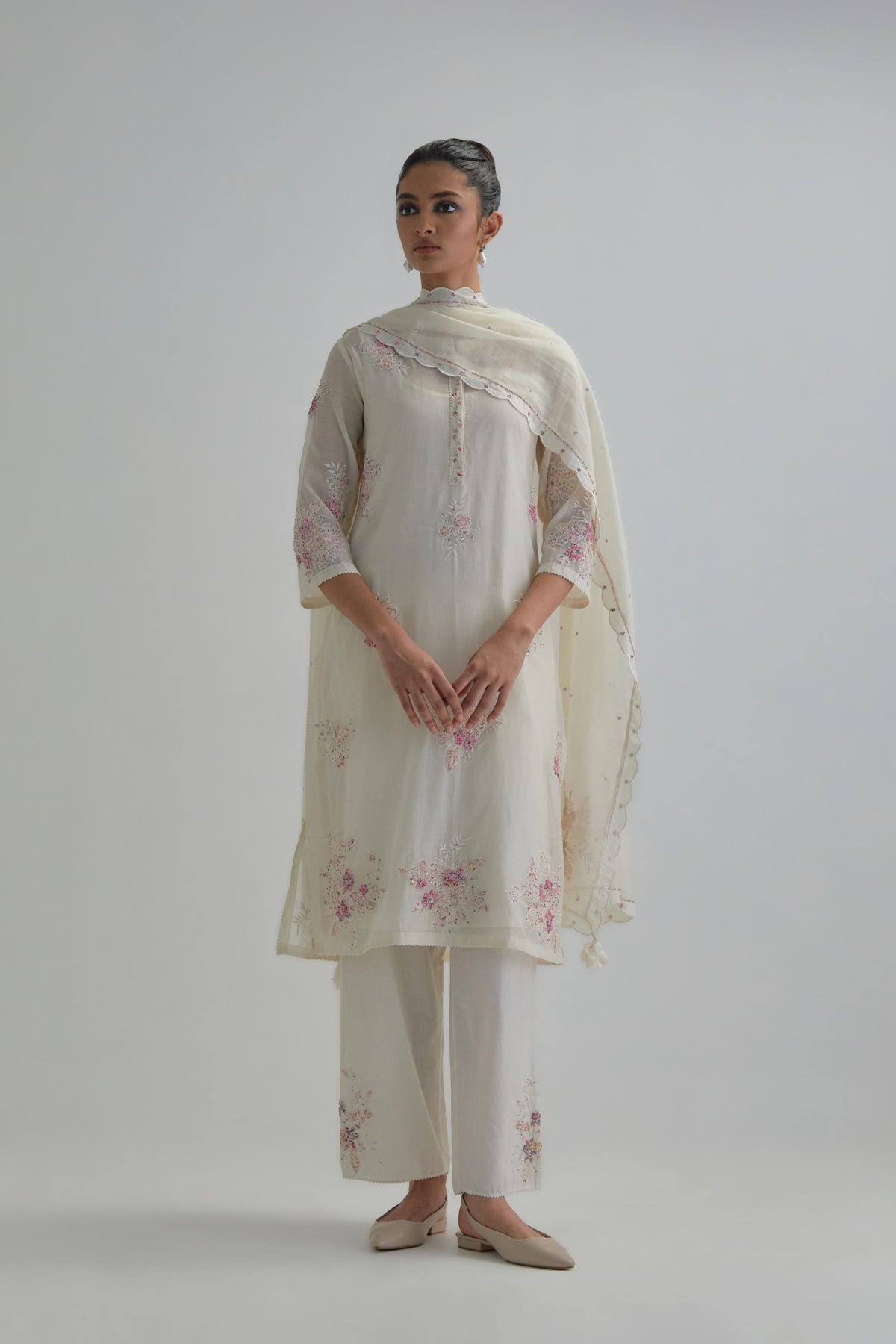Off white straight short kurta set with all-over pink & beige hand block printed appliqué motifs, highlighted with sequins and multi coloured beads.