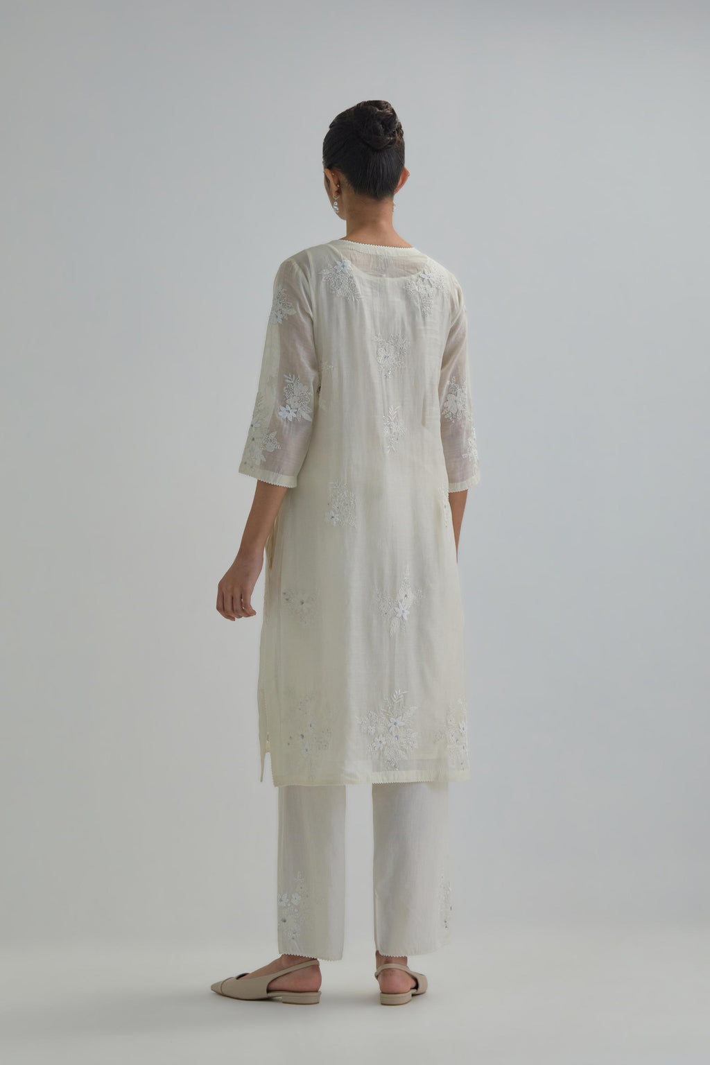 Off white straight short kurta set with all-over appliqué motifs, highlighted with sequins and beads.