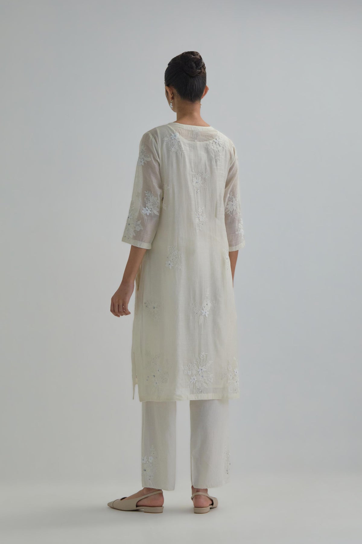 Off white straight short kurta set with all-over appliqué motifs, highlighted with sequins and beads.
