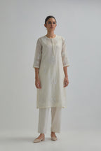 Off white straight short kurta set with all-over appliqué motifs, highlighted with sequins and beads.