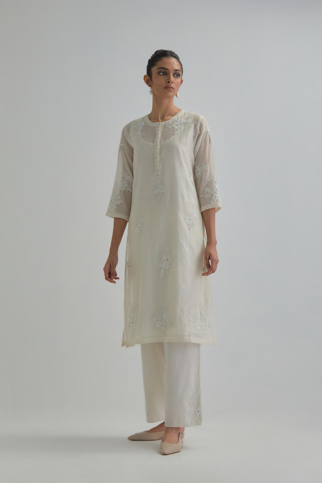 Off white straight short kurta set with all-over appliqué motifs, highlighted with sequins and beads.