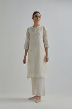 Off white straight short kurta set with all-over appliqué motifs, highlighted with sequins and beads.