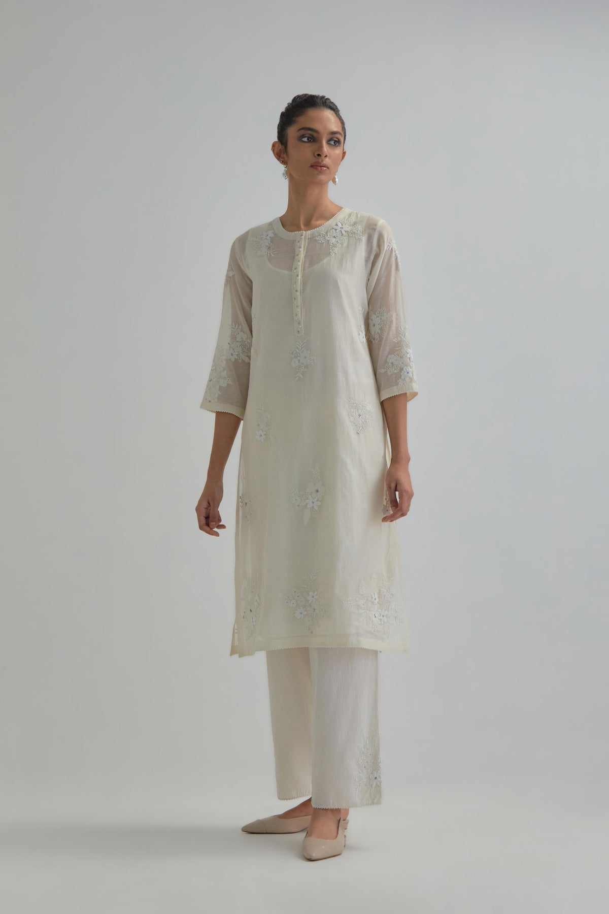 Off white straight short kurta set with all-over appliqué motifs, highlighted with sequins and beads.