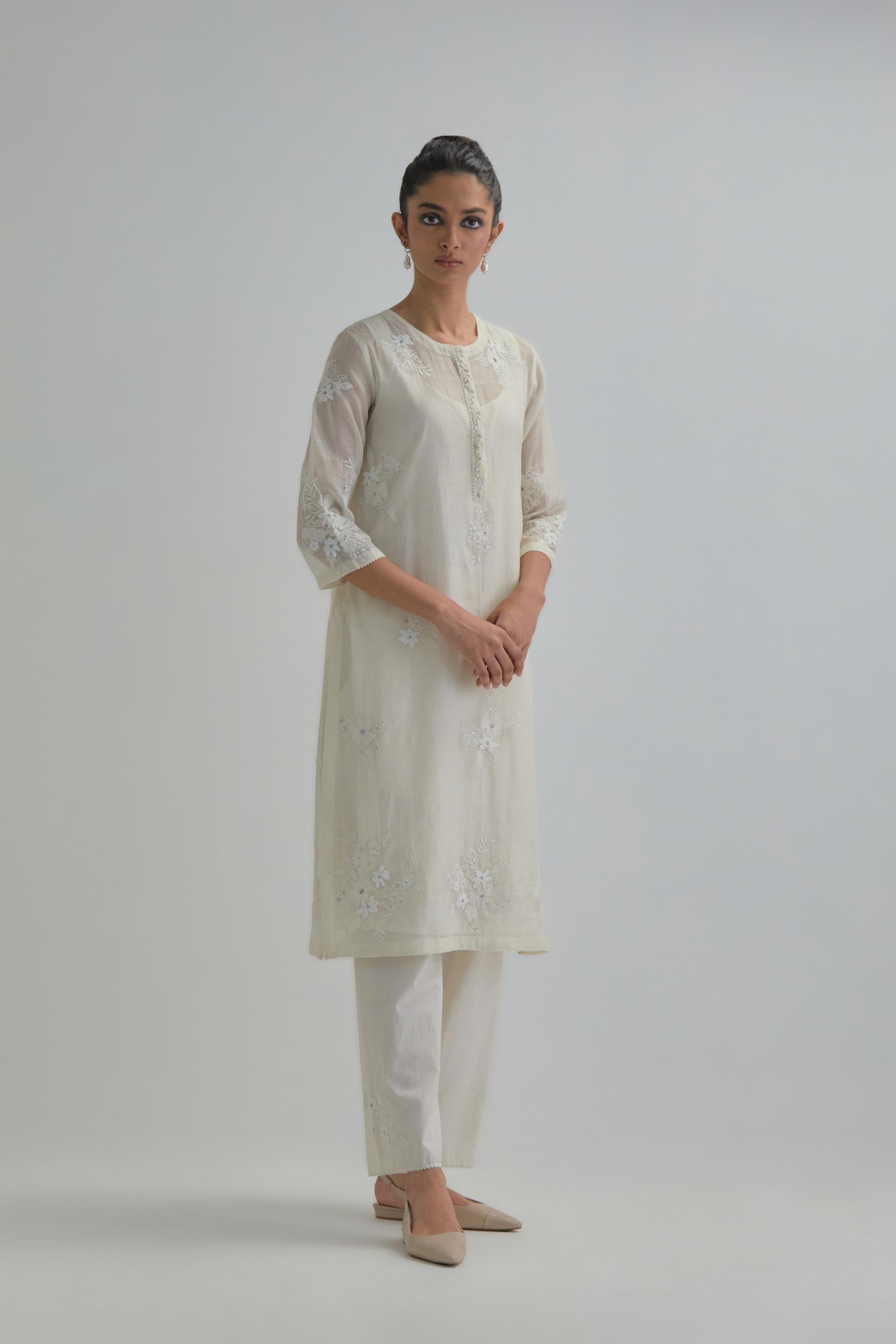 Off white straight short kurta set with all-over appliqué motifs, highlighted with sequins and beads.