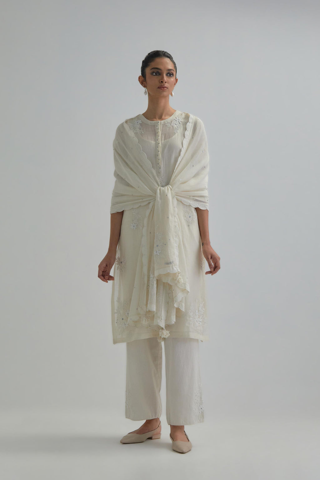 Off white straight short kurta set with all-over appliqué motifs, highlighted with sequins and beads.