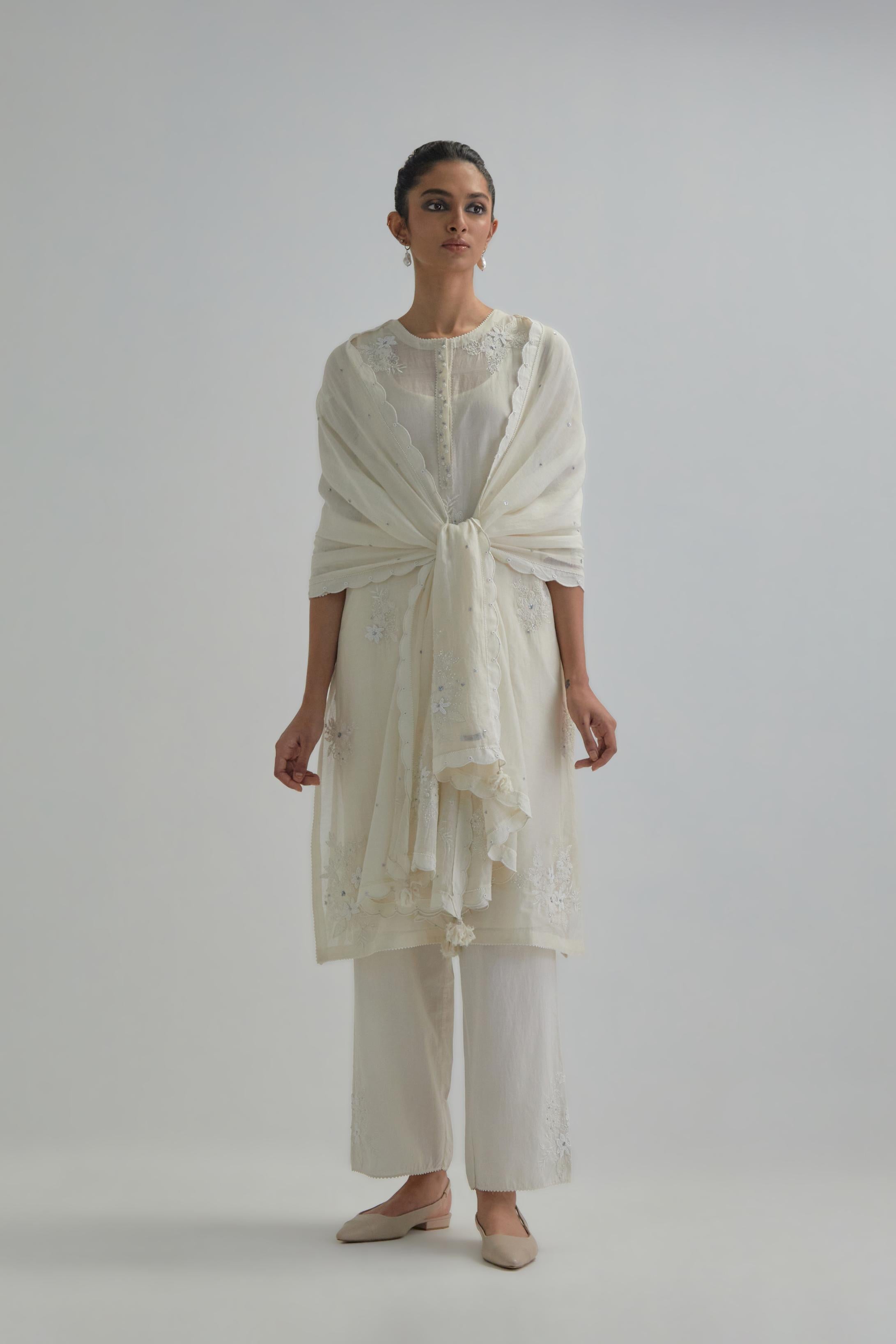 Off white straight short kurta set with all-over appliqué motifs, highlighted with sequins and beads.