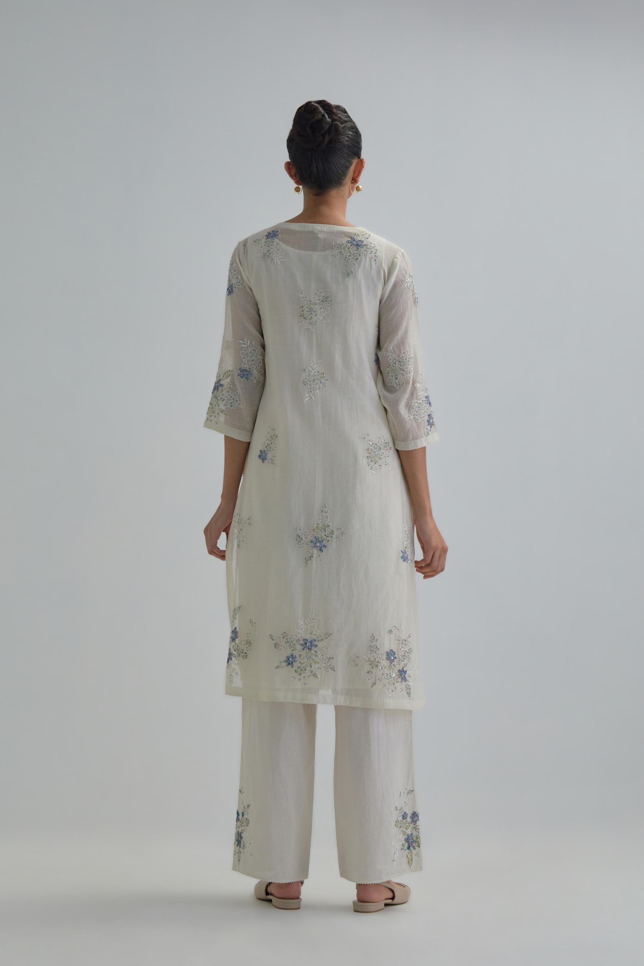 Off white straight short kurta set with all-over blue & beige hand block printed appliqué motifs, highlighted with sequins and multi coloured beads.