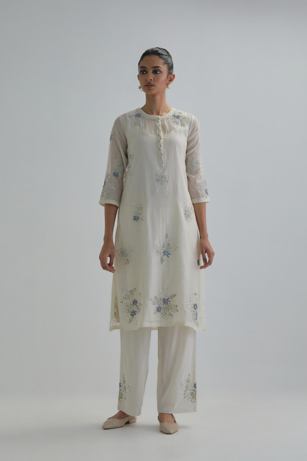 Off white straight short kurta set with all-over blue & beige hand block printed appliqué motifs, highlighted with sequins and multi coloured beads.
