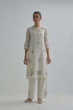 Off white straight short kurta set with all-over blue & beige hand block printed appliqué motifs, highlighted with sequins and multi coloured beads.