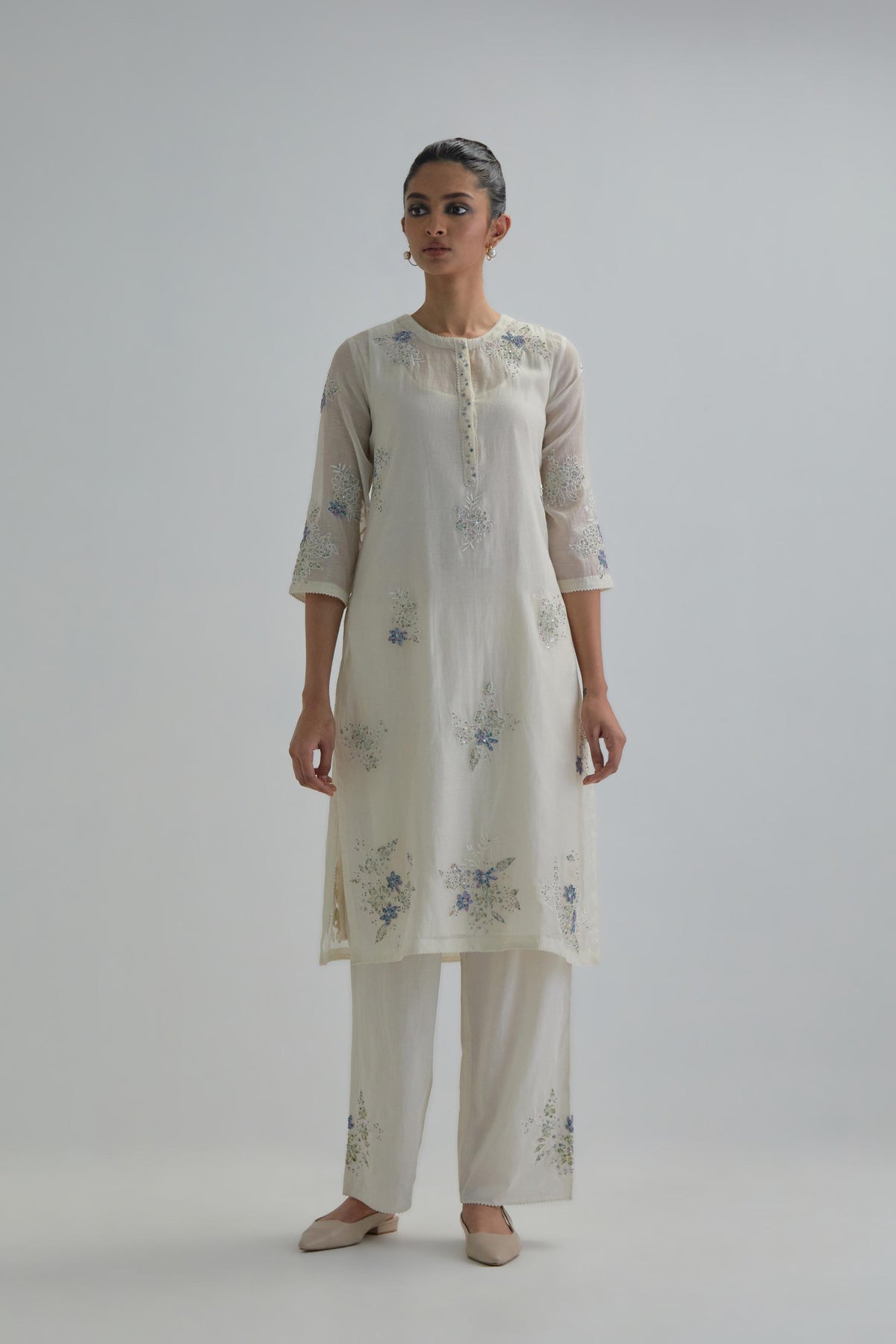 Off white straight short kurta set with all-over blue & beige hand block printed appliqué motifs, highlighted with sequins and multi coloured beads.