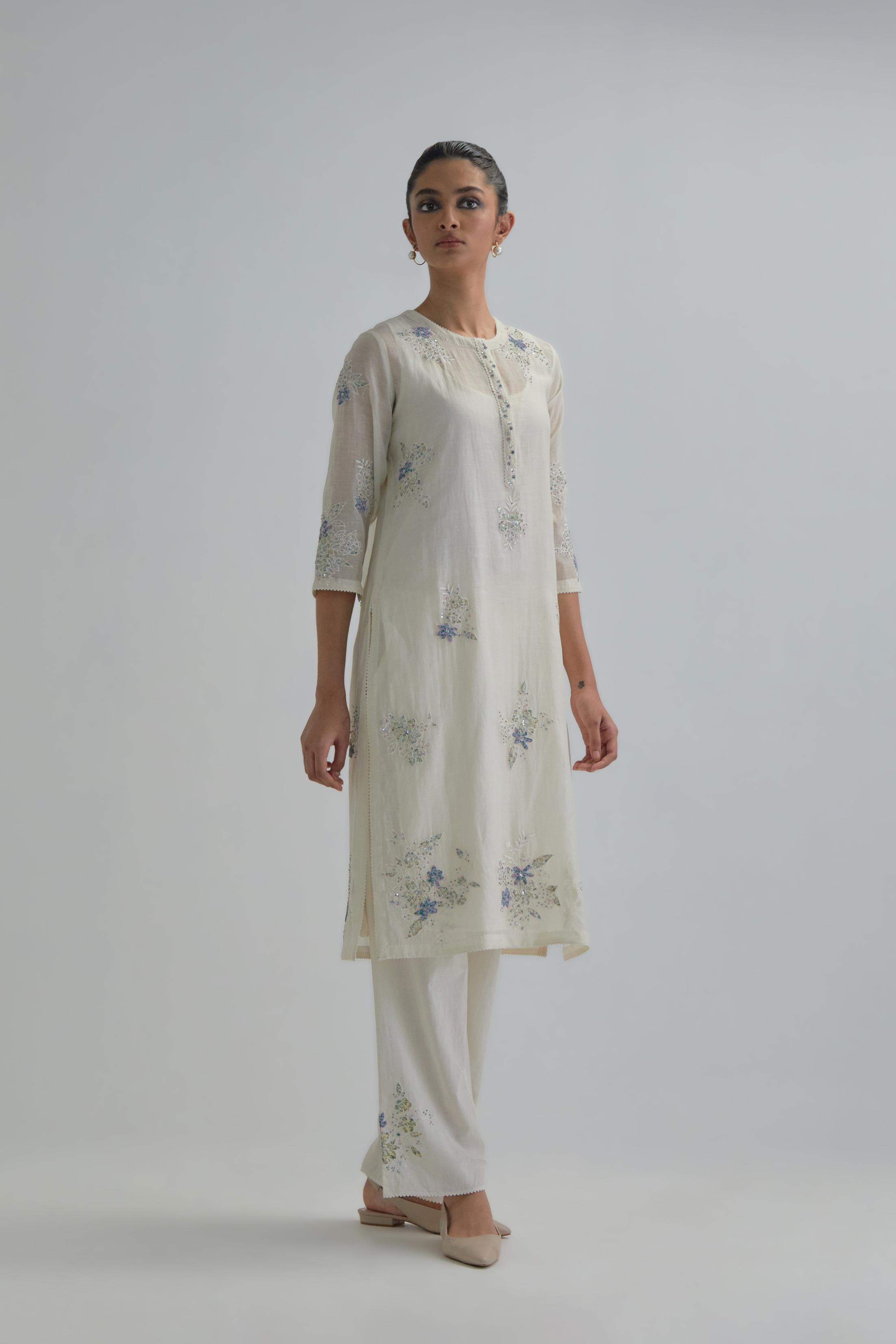 Off white straight short kurta set with all-over blue & beige hand block printed appliqué motifs, highlighted with sequins and multi coloured beads.
