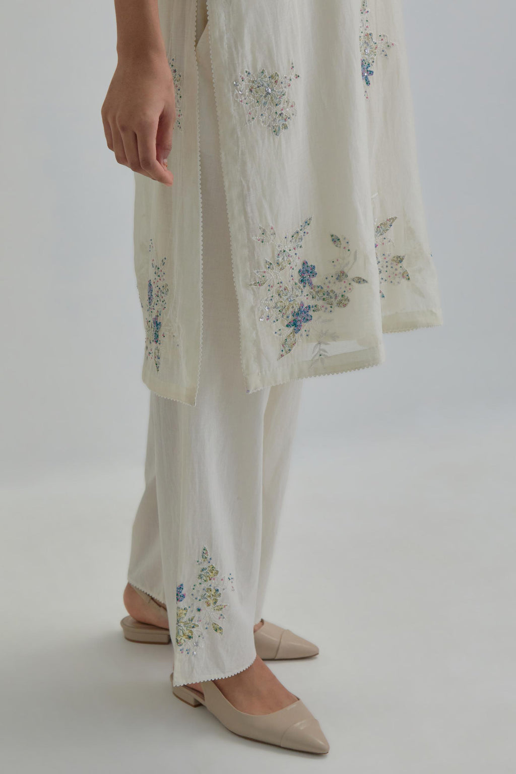 Off white straight short kurta set with all-over blue & beige hand block printed appliqué motifs, highlighted with sequins and multi coloured beads.