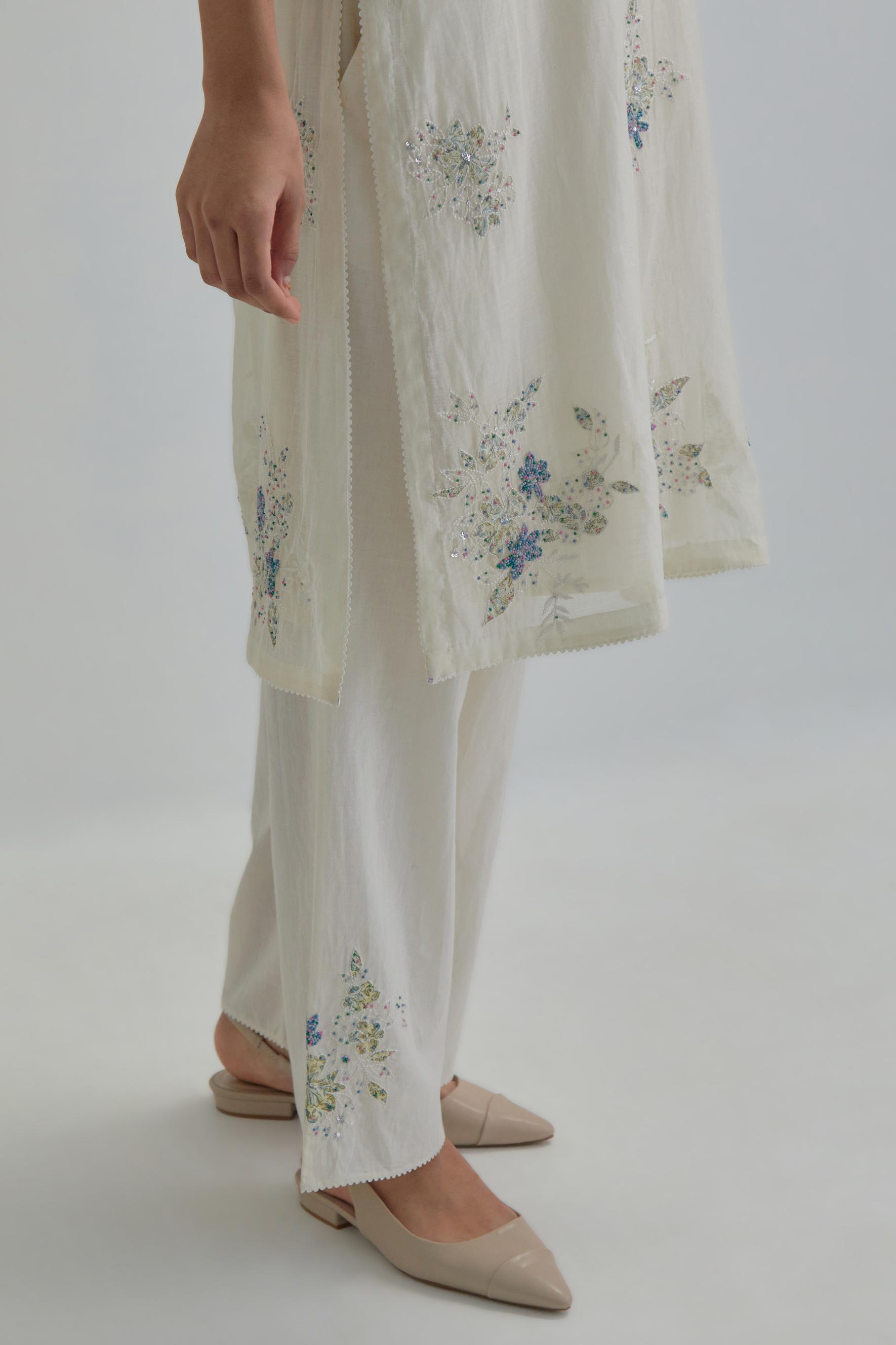 Off white straight short kurta set with all-over blue & beige hand block printed appliqué motifs, highlighted with sequins and multi coloured beads.